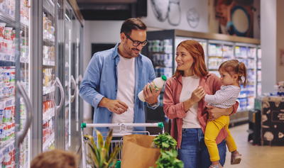 Happy Family Shopping Together in a Supermarket Dairy Aisle