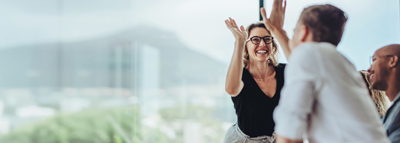 Businesswoman giving a high five to a colleague in meeting
